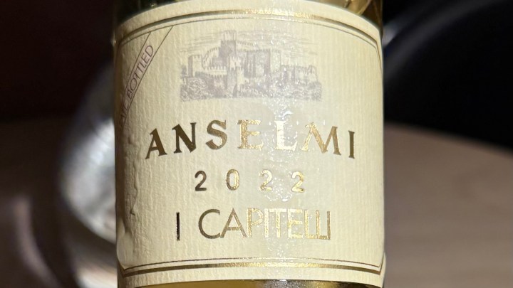 Close-up of a wine bottle labeled 'Anselmi 2022 I Capitelli'.
