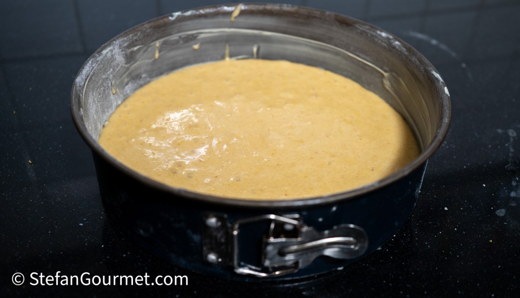 Batter for raspberry and almond cake in a springform pan, ready for baking.