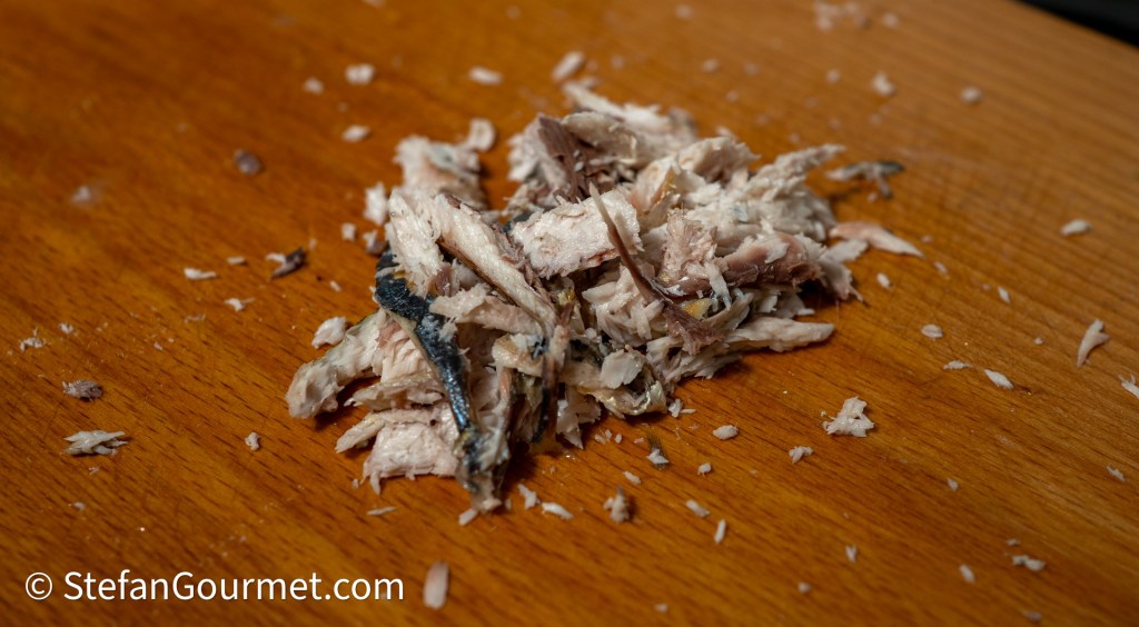 Shredded fish on a wooden surface.