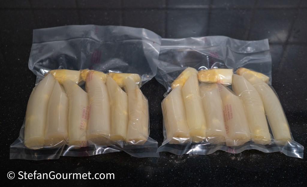 Two vacuum-sealed packages containing multiple pieces of white and yellow food items, placed on a dark surface.