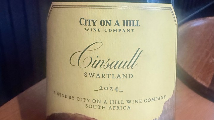 Label of a Cinsault wine bottle from City on a Hill Wine Company, South Africa, vintage 2024, featuring a cream background with green text.